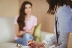 Therapist Leading Session with Woman During Addiction Treatment