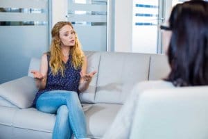 Woman and Therapist Engaged in Addiction Therapy