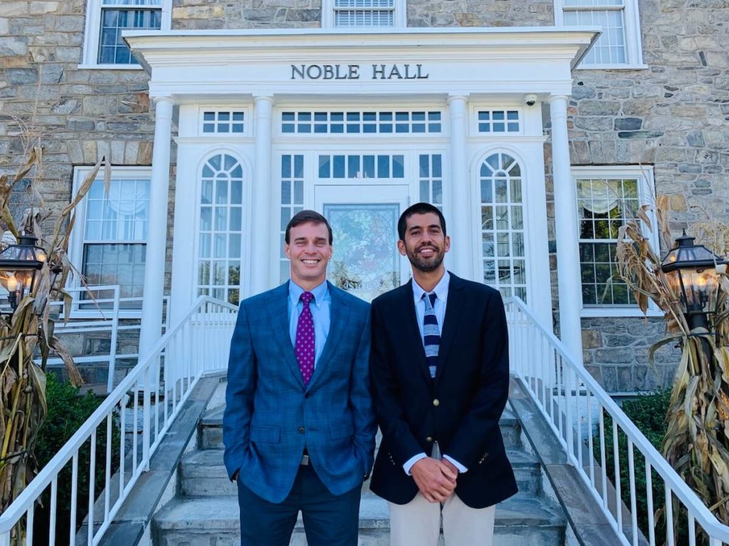 Photo of Alex Denstman, MBA and Greg Hobelmann, M.D., MPH standing in front of Noble Hall