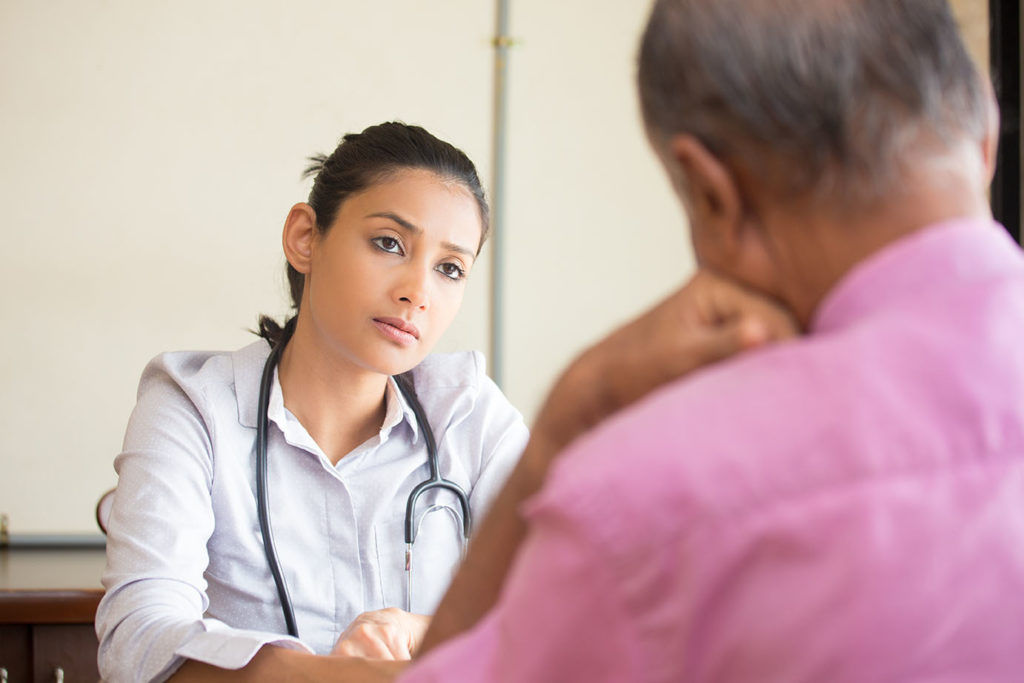 Closeup portrait, patient talking serious conversation to healthcare professional, isolated indoors background